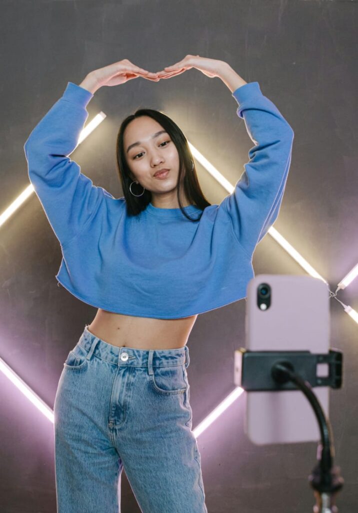 Young social media influencer creating content on phone for YouTube Shorts and Instagram Reels