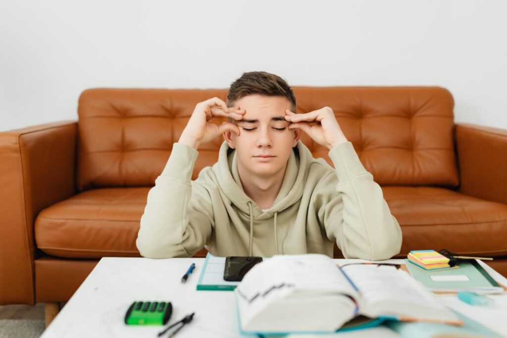 Confused Indian student with books unsure about career path