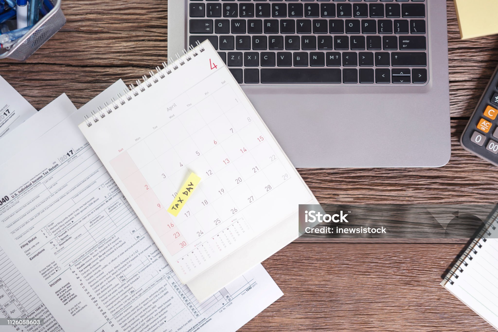 Accountant working on income tax audit with calendar highlighting due date
