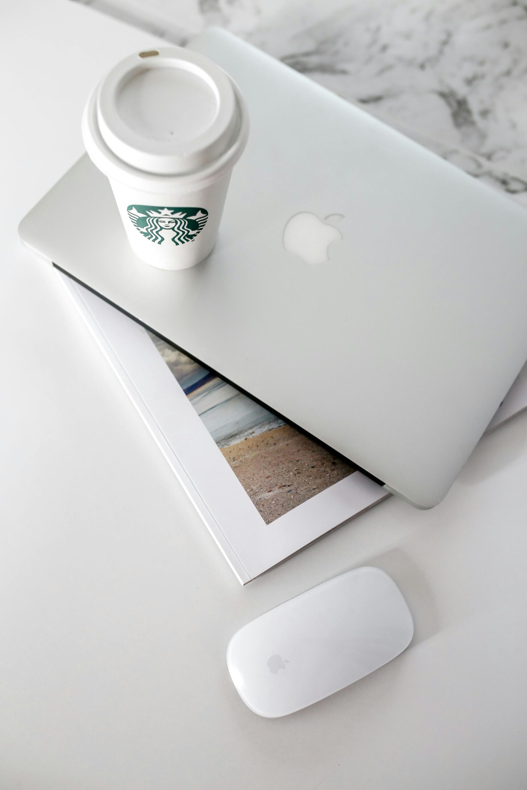 : Apple MacBook Air EM4D on desk with discount tags for Amazon Great Indian Festival 2025