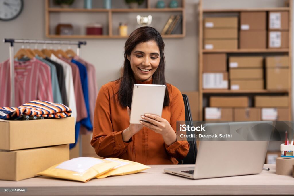 Small business owner packing product for online delivery