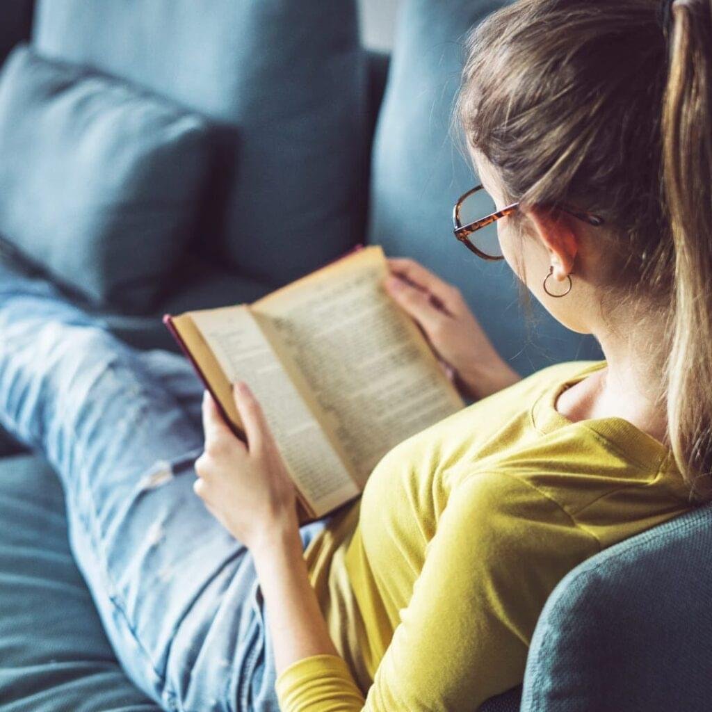 Youth reading Atomic Habits to improve focus and routine.